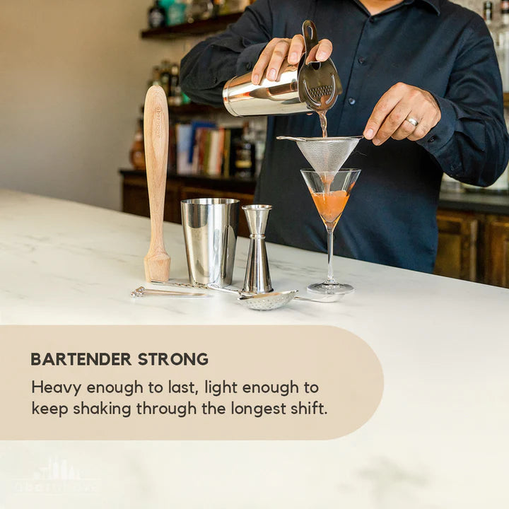 Bartender holding shaker and strainer