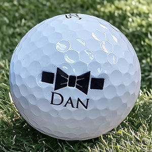 White golf ball with 'DAN' logo engraved on the ball